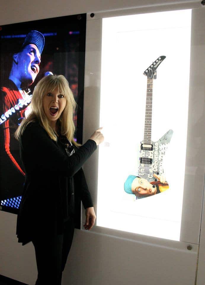 Shannon with one of many of Rick Nielsen’s guitars she has painted for him. Shannon Macdonald, Artist, on The Table Read.