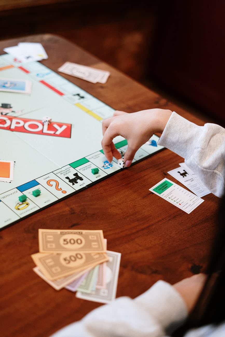 monopoly board game on brown wooden table